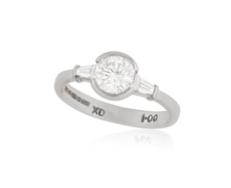 A DIAMOND SINGLE-STONE RINGThe brilliant-cut diamond between tapered baguette-cut diamonds, mounted in 18K gold, ring size K 