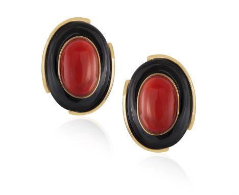 A PAIR OF CORAL AND ONYX EARCLIPSEach oval-shaped polished openwork mount, set with an oval-shaped cabochon coral and polishe