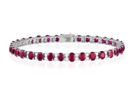 A RUBY AND DIAMOND LINE BRACELETSet with oval-shaped rubies between brilliant-cut diamond spacers, mounted in 18K white gold,