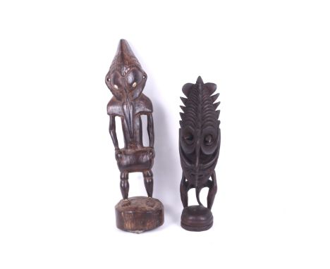 Papua New Guinea. Two Sepik River ancestral standing figures. The first with patterned headdress and shawl, elongated trunk, 