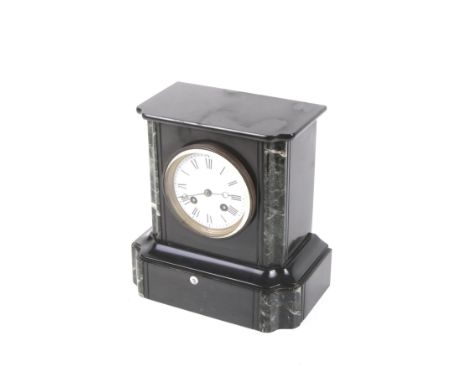 A Victorian mantel clock. The white enamel dial with Roman numerals, in a slate case with green marble details, H22.5cm