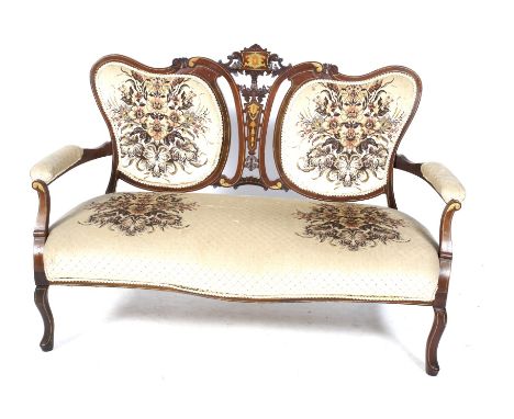 An Edwardian inlaid mahogany parlour sofa. The mahogany frame having carved and pierced details to the top, the padded arm re