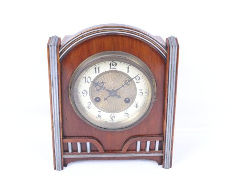 A 20th century Art Deco style mantel clock. The brass dial having Arabic numerals, the wooden case with a domed top and paint