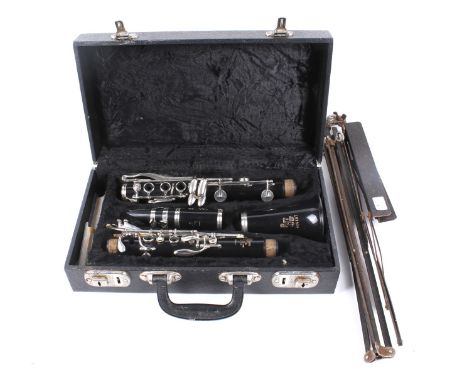 A Boosey & Hawkes Regent clarinet with fitted case and a music stand. Clarinet S/N 490264. 