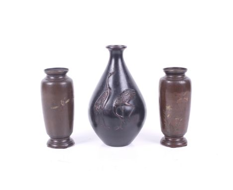 A pair of small bronze Japanese Meiji period vases and a further vase with cranes. The first with mixed metal decoration of w