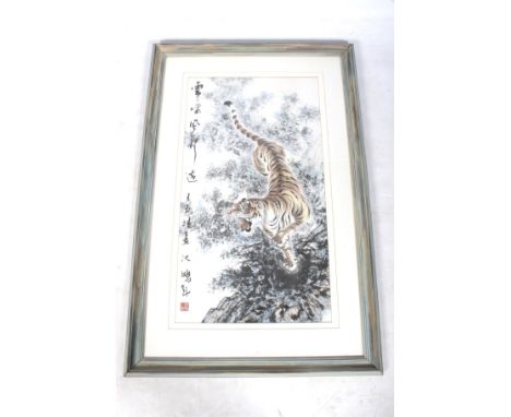 A Chinese or Korean painting on paper of a growling tiger. With an inscription and seal to the left. 81cm x 44cm, framed and 