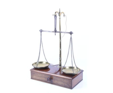 A set of Victorian Avery brass balance scales. Raised on a mahogany base with drawer and contents. H60cm x W41cm x D22cm