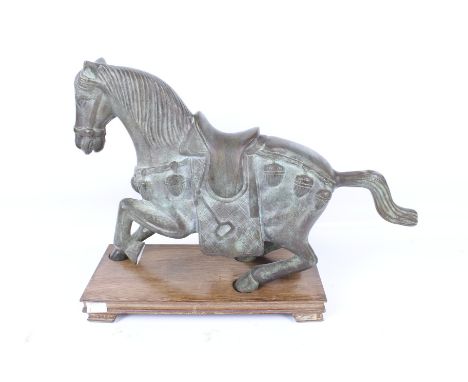 A large bronze Chinese style horse. In a prancing position, mounted on a wooden stand, unmarked. H33cm