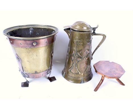 Three assorted Arts and Crafts style metalware items. Including a Joseph Sankey & Son, Bilston brass jug with hinged cover, a
