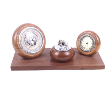 A mid-century Ryecraft Woodware desk set. Consisting of an aneroid barometer, a thermometer and a table lighter. H12cm