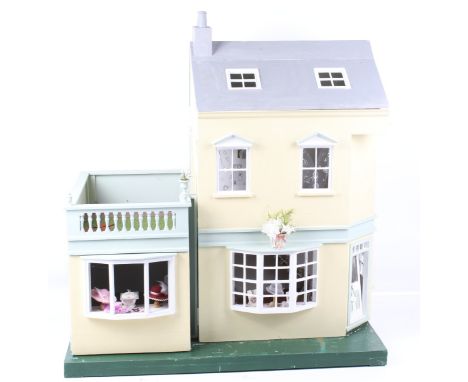A contemporary dolls house. The yellow and blue large house is an American house from Walmer and is a Strawberry Patch.  When