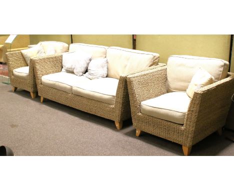 A contemporary rattan three piece sofa suite. All having grey cushions, on tapered wooden supports, sofa H70cm (frame) x W198