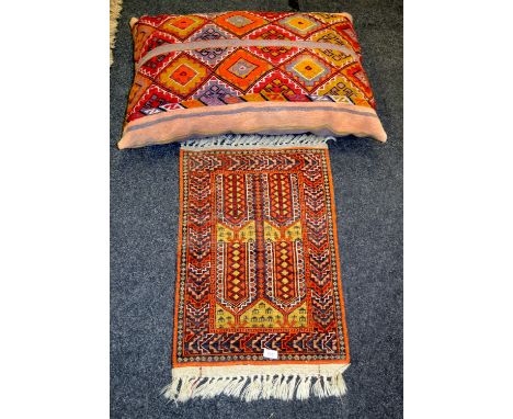 A Persian wool prayer mat in tones of terracotta; a carpet cushion geometric pattern (2)