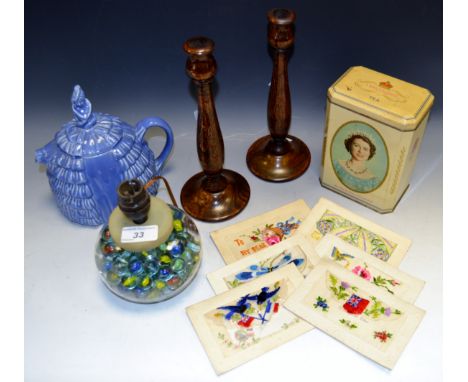 A pair of oak turned candlesticks; a table lamp, the base filled with marbles; a Crinoline Lady teapot; commemorative tin; si