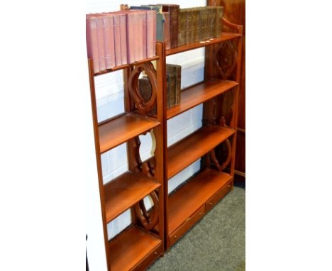 A modern mahogany shelf unit, four shelves, two short drawers to base; another, smaller, four shelves, single drawer.