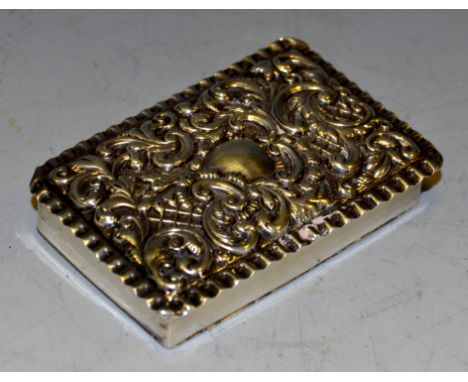 A late Victorian silver shaped rectangular snuff box, hinged cover embossed with scrolling foliage and trellis, Birmingham 19