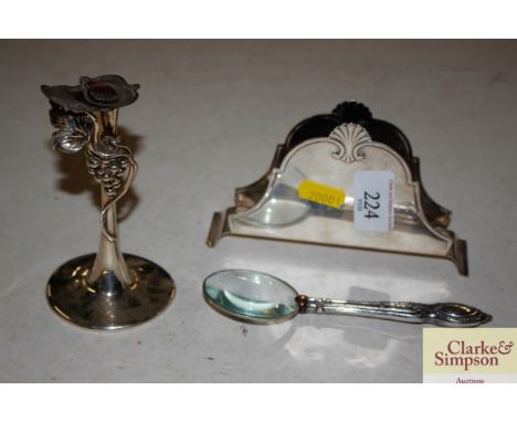 A silver handled eye glass; a white metal Art Nouveau design stand and a white metal napkin holder marked G.A.B NS ALP