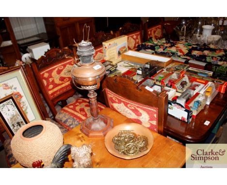 A table oil lamp with copper font, a small copper shallow tray and a quantity of horse brasses