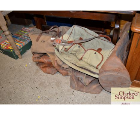 A collection of various vintage leather and canvas holdalls etc
