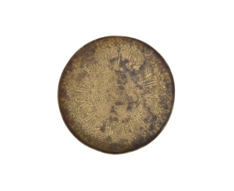AN ENGRAVED BRASS SELJUK SAUCER WITH KUFIC CALLIGRAPHY Iran, 12th - 13th centuryOf typical circular shape with a raised rim, 