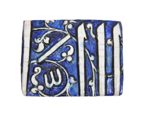 A MOULDED CALLIGRAPHIC POTTERY TILE FRAGMENT Timurid Iran or Central Asia, 15th centuryOf rectangular shape, painted in cobal