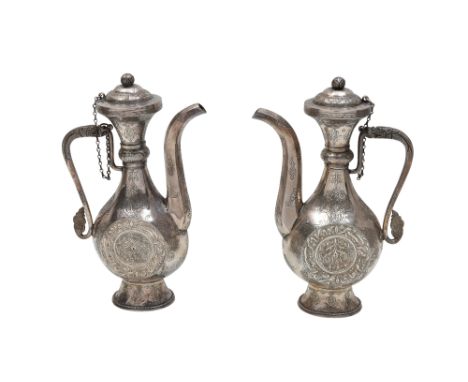 A PAIR OF SILVER EWERS WITH NASTA'LIQ CALLIGRAPHY AND DRAGON HANDLES Ladakh or Kashmir, Himalayan plateau, Northern India, 19