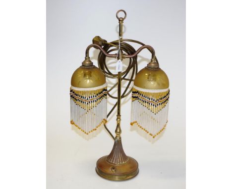 Vintage brass based decorated electric table lamp dual amber glass light shades with extensive suspended drop decoration, on 