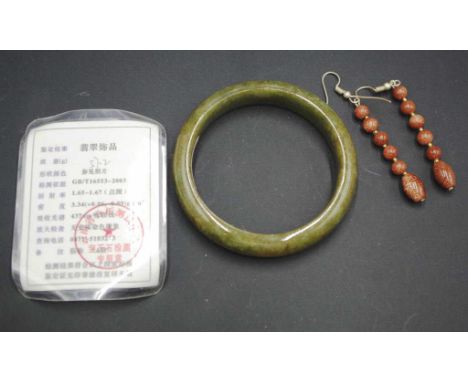 Chinese green hardstone bangle together with a pair of earrings