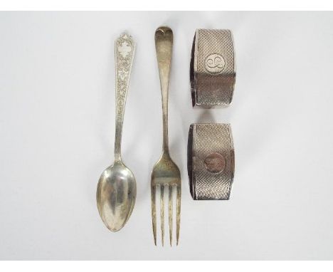 Lot to include a pair of George V silver napkin rings, Birmingham assay 1926, a Joseph Rodgers and Sons fork, Sheffield assay