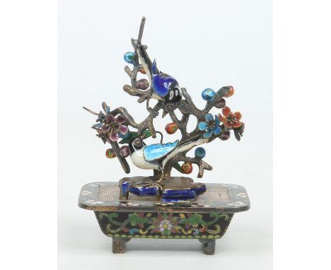 An early 20th century Chinese cloisonne and enamel silver miniature model of a blossoming tree, with two birds perched upon i