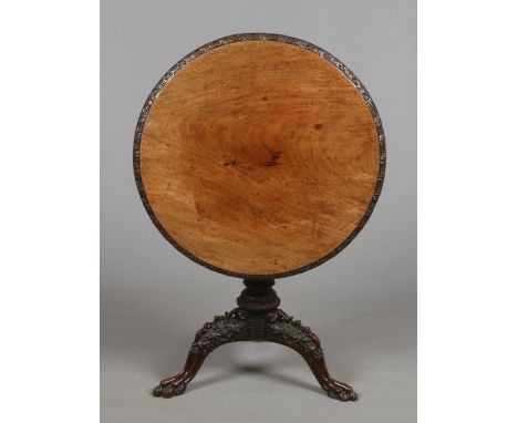 An early 19th century Anglo Indian carved mahogany snap top tripod table. With pierced frieze carved with trailing flowers. R