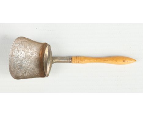 A George III silver caddy spoon with turned ivory handle and engraved with flowers. Assayed Birmingham 1822.  Condition Repor