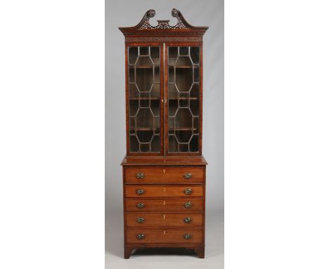 An early 19th century Chippendale style mahogany secretaire bookcase of small proportions. With open fret swan neck pediment 