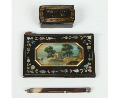 A Regency lacquered papier mache pocket book painted with a landscape scene and inlaid with abalone shell, a papier mache snu