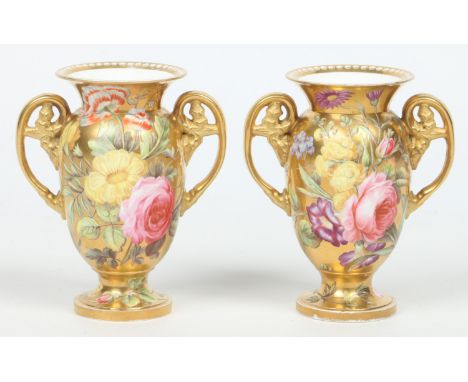 A rare pair of Spode twin handled vases. Gilt ground and enamelled all over with flowers and with pearls to the rims. Unmarke