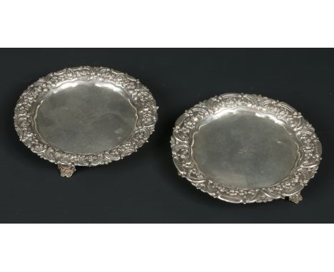 A small pair of early 19th century Portuguese silver salvers. Each engraved with a crest of a bird over a coronet. With repou