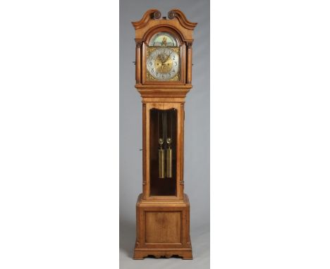 A Victorian oak cased 8 day longcase clock with Corinthian column supports and bevelled glass door panel. With brass arch top