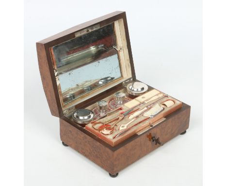 A fine 19th century French burr walnut fitted necessaire and accoutrements. With silver mounted glass dressing table bottles,