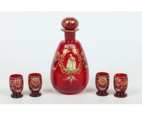 An early 20th century ruby glass liqueur set. With gilt scrollwork, enamelled with roses and figures in 18th century attire. 
