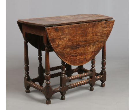 A period oak gateleg dining table. Raised on turned supports with bobbin turned cross stretchers, 74cm high. 92cm x 50cm clos