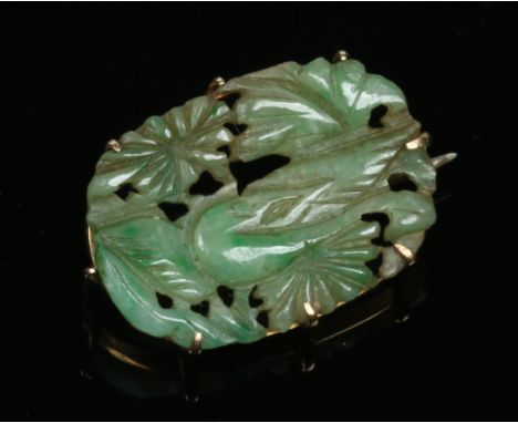 A Chinese pierced jade tablet mounted as a brooch in 9 carat gold, 2.75cm. Condition Report. To be used as a guide only. Good
