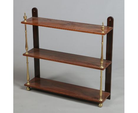 A William IV rosewood three tier hanging wall shelf with brass supports and urn shaped finials, 74cm wide. 