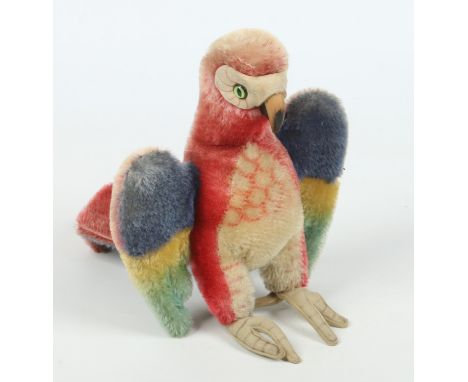 A 1950s Steiff parrot "Lora". Button mark to one wing, 23cm. Condition Report. To be used as a guide only. Colours faded.