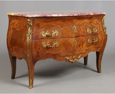 A 19th century French bombe shaped kingwood two drawer commode chest. With serpentine rosso marble top and having rococo styl