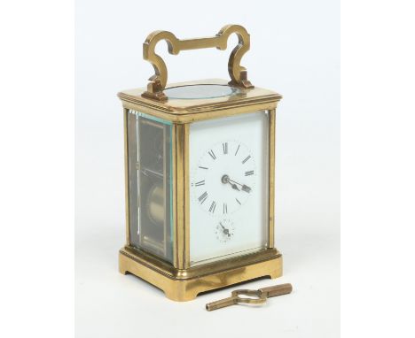 A late 19th century French brass cased carriage alarm clock. With enamel dial incorporating a subsidiary dial for an alarm fu