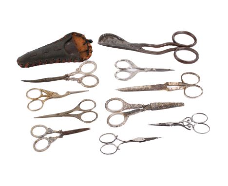 A collection of antique and vintage sewing scissors. Including a pair of Mappin & Webb silver handled scissors, hallmarked 19
