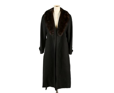 A vintage Aquascutum black cashmere full length coat. Retailed by Harrods, having a brown fur collar, two slip pockets and a 