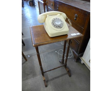 An oak occasional table and a vintage telephone