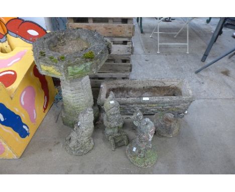 A concrete garden trough, bird bath and four garden gnomes/figures