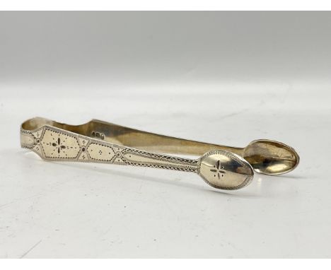 Georgian silver sugar tongs with engraved detailing and monogram. Makers mark for George Wintle, the hallmark and duty mark f